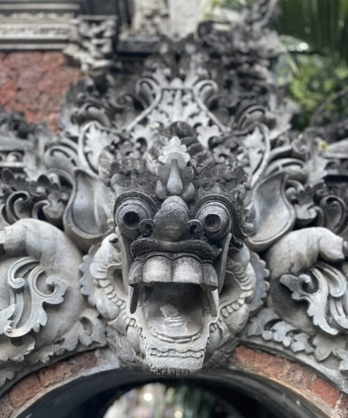 Traditional stone dragon carving at the entrance to Kubu Elsa Bali