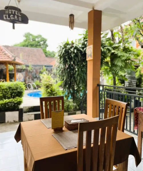 Breakfast table overlooking the tropical garden and swimming pool
