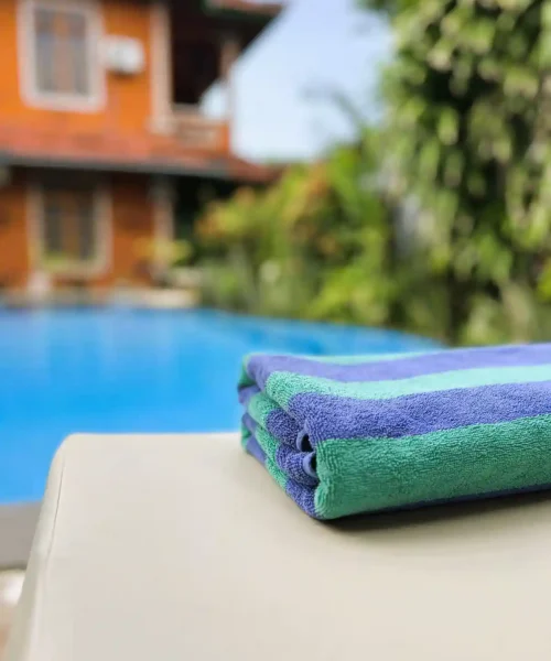 Folded towels on a pool lounger at Kubu Elsa Bali