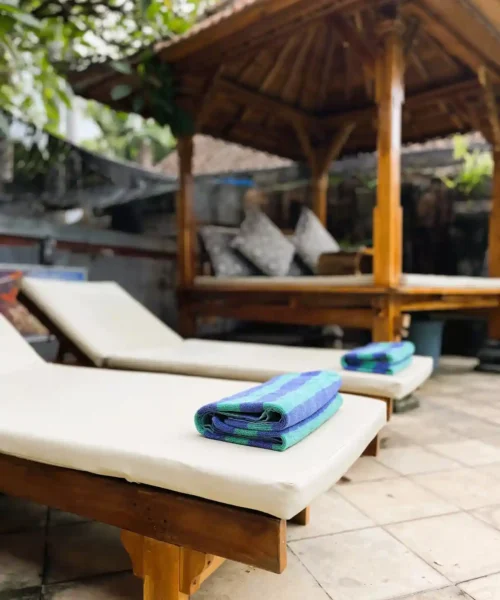 Two pool loungers prepared with folded towels